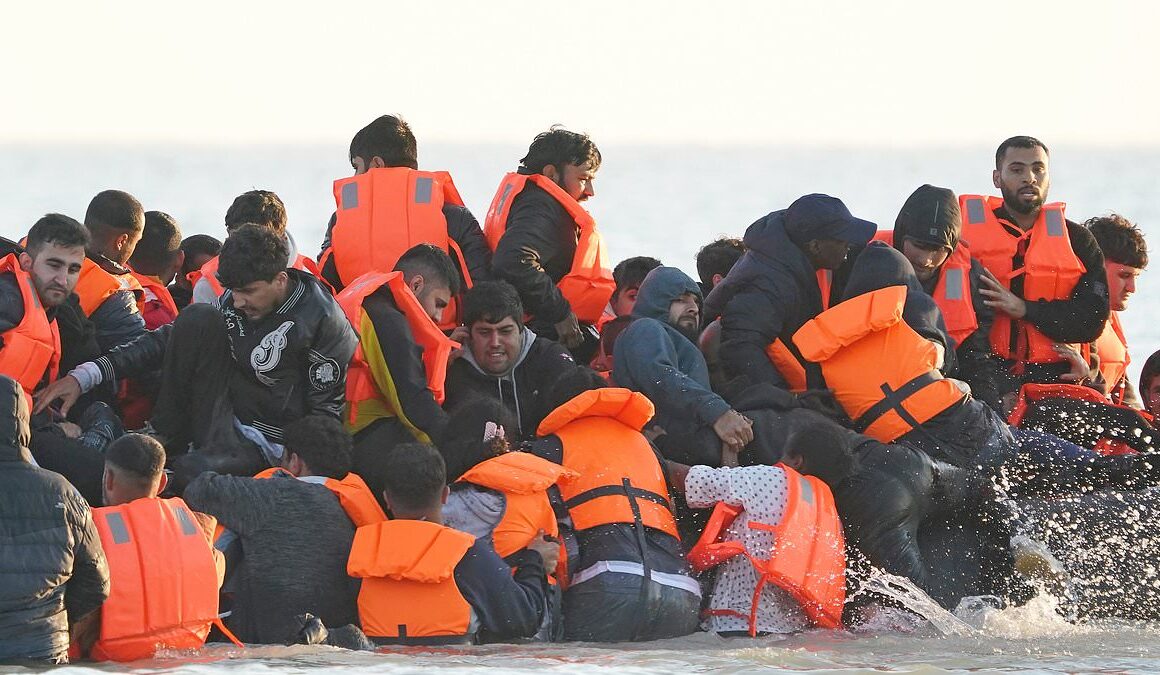 Migrant shouts ‘This is for Rishi Sunak’ as his inflatable boat leaves France towards the English Channel, stopping to collect more people at Calais in full view of French police