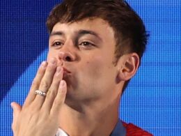 ‘It’s very moving’: Tom Daley’s husband Dustin Lance Black chokes back tears as he says it was ‘so special’ for their sons to watch their father win a silver medal – as Team GB star blows them kisses from the podium