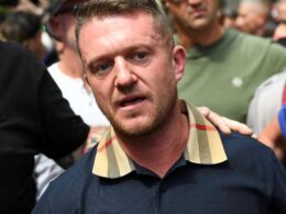 Tommy Robinson posts lyrics to anti-Apartheid song Something Inside So Strong while on the run after ‘fleeing the country’ on eve of contempt court case – as warrant issued for his arrest