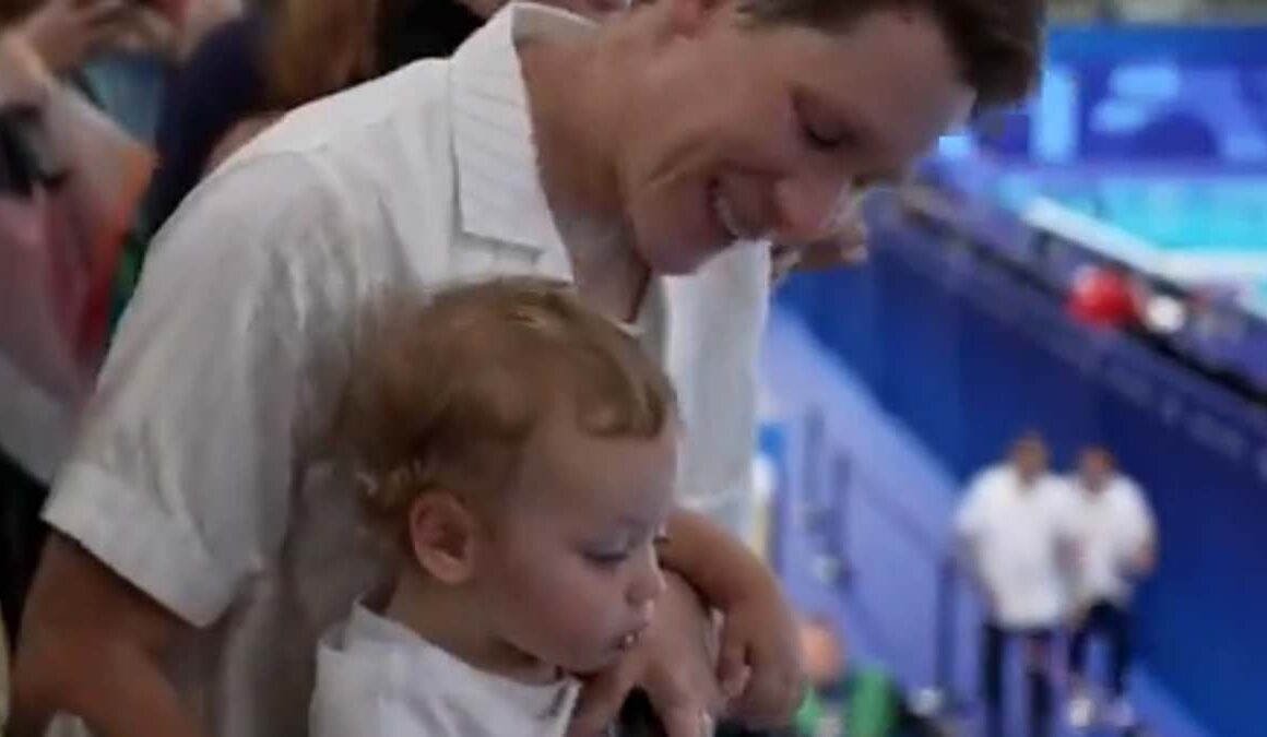 Moment Tom Daley is nearly soaked in fruit juice by his one-year-old son Phoenix after winning silver at the Paris Olympics