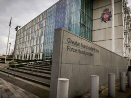 Greater Manchester Police suspends 13 officers from the same district over racism claims: Force refers itself to watchdog as three more are placed on restricted duties