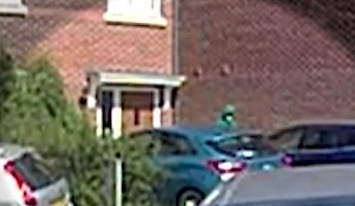 Chilling moment hooded and masked figure paces outside house 20 minutes before two children were stabbed to death at Taylor Swift-themed dance workshop – as footage shows armed police preparing to raid the same property hours later