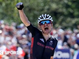 Pidcock defies puncture to retain Olympic title