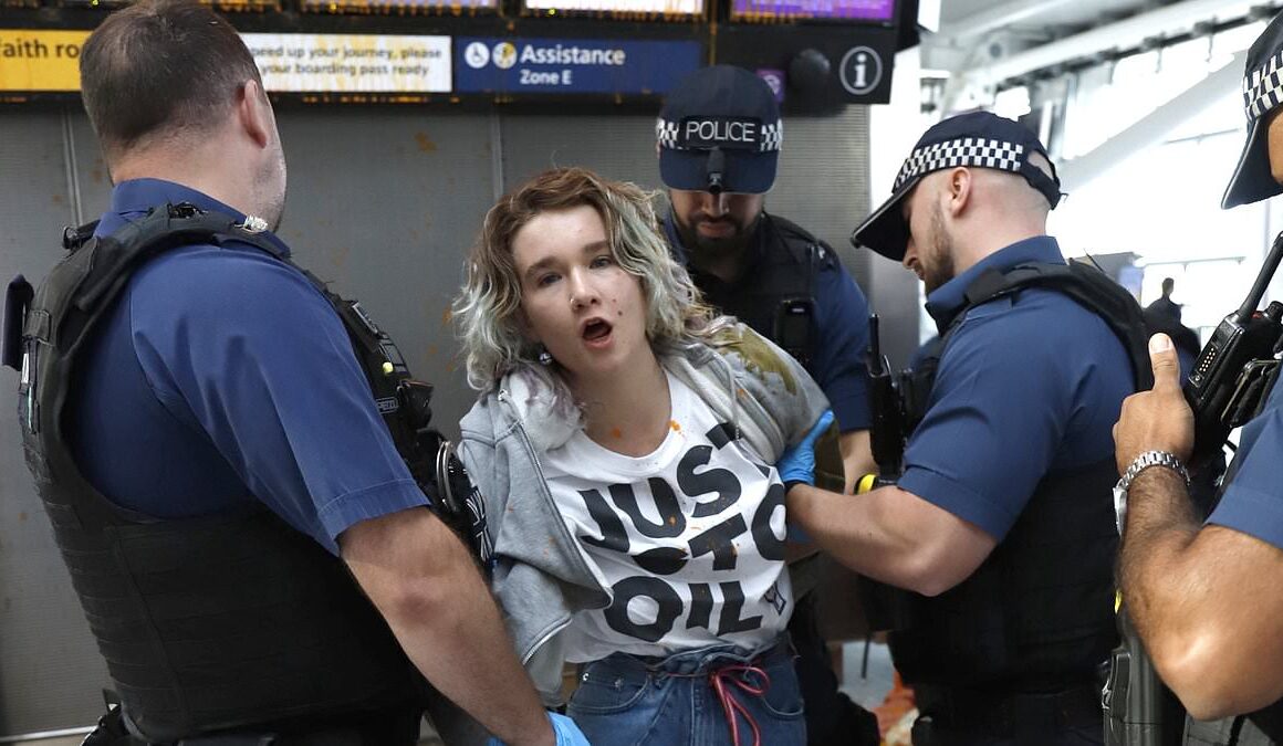 Just Stop Oil eco-clowns play dead as they are arrested for spraying Heathrow Airport with orange paint as  part of ‘summer chaos’ crusade – forcing FIVE officers to drag their slumped bodies out of departures