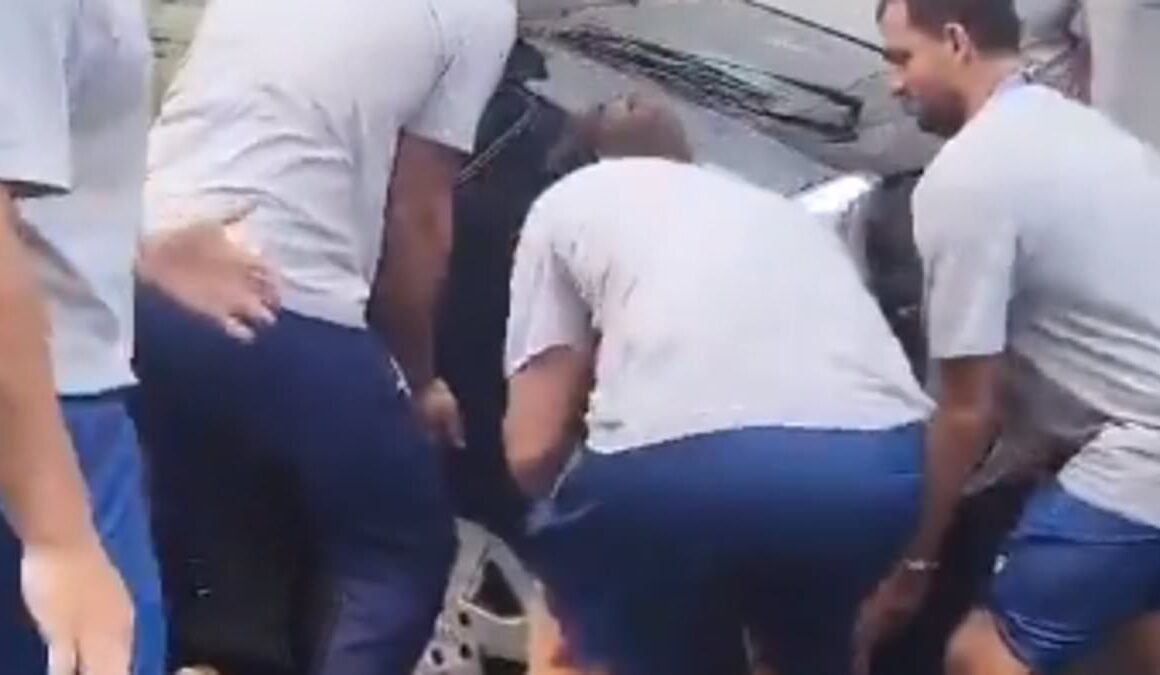 Hilarious moment Greek Olympic water polo team lift badly parked car so their bus can squeeze down narrow Paris street