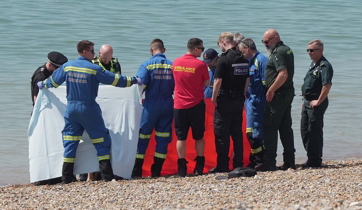 Body of man is found on busy Sussex beach on the hottest day of the year – as police launch investigation to determine his identity