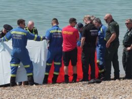 Body of man is found on busy Sussex beach on the hottest day of the year – as police launch investigation to determine his identity