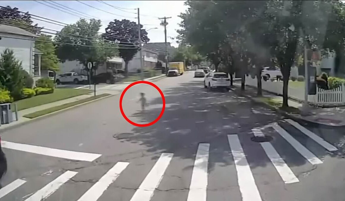 Terrifying dashcam shows four-year-old in just a diaper and tank top and clutching an iPad wandering into busy intersection – what happens next will warm your heart