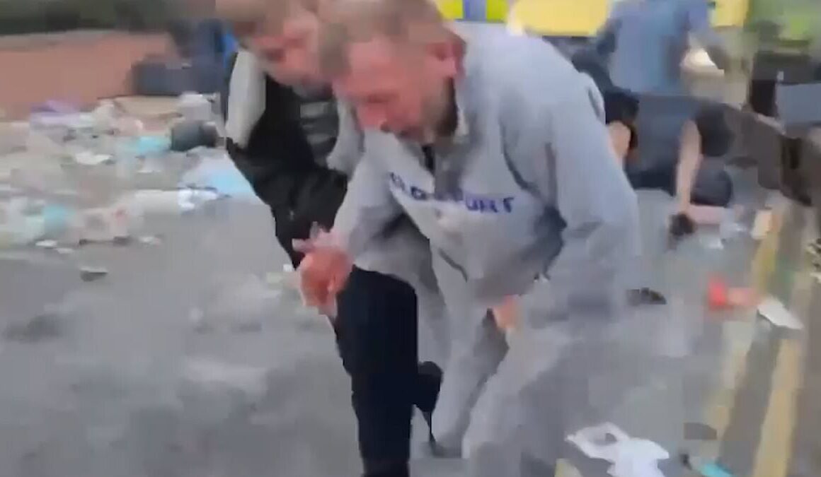 Moment rioter gets hit in the head with a brick… and then again where it REALLY hurts during violent clashes with police in Southport