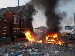 Calls for calm as Southport locals say thugs who torched a police van and hurled missiles at a mosque in violent clashes which left 22 officers injured have ‘no respect for a town that’s grieving’