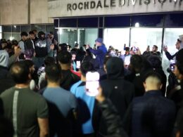 Crowd of hundreds mass overnight outside police station where men from Manchester Airport video were taken after chaotic incident where cop kicked and stamped on man’s head chanting ‘GMP shame on you’