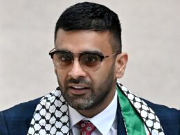 Revealed: Lawyer representing two men being ‘attacked’ by police at Manchester Airport is Lamborghini-driving wannabe MP who ran as pro-Palestine candidate in the general election