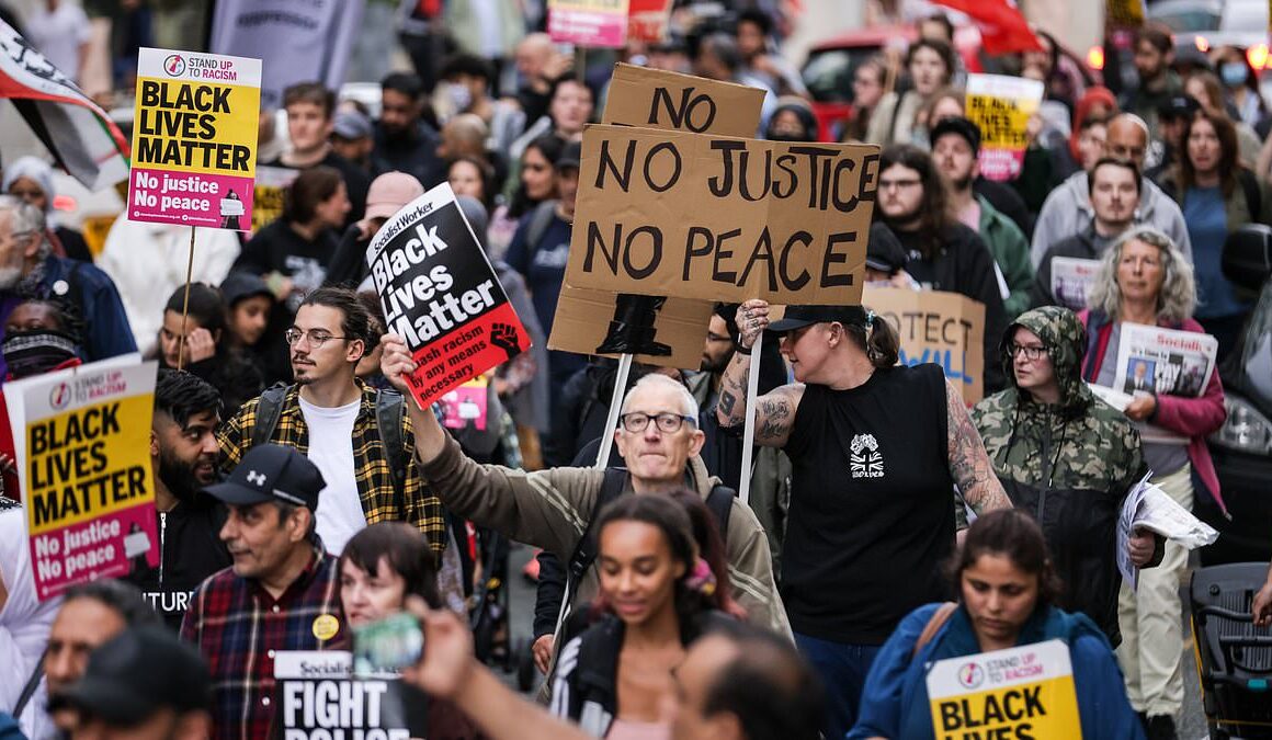 Crowds of protesters block roads and trams in Manchester city centre branding police ‘racist’ and calling for cops to be sacked over airport ‘kicking and stamping’ attack – as watchdog opens second probe and sets up witness hotline