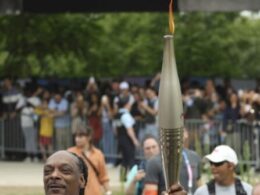 Snoop Dogg Carries the Olympic Torch Before Opening Ceremony in Paris