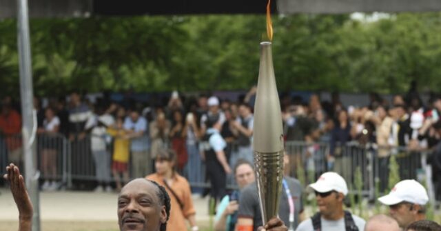 Snoop Dogg Carries the Olympic Torch Before Opening Ceremony in Paris