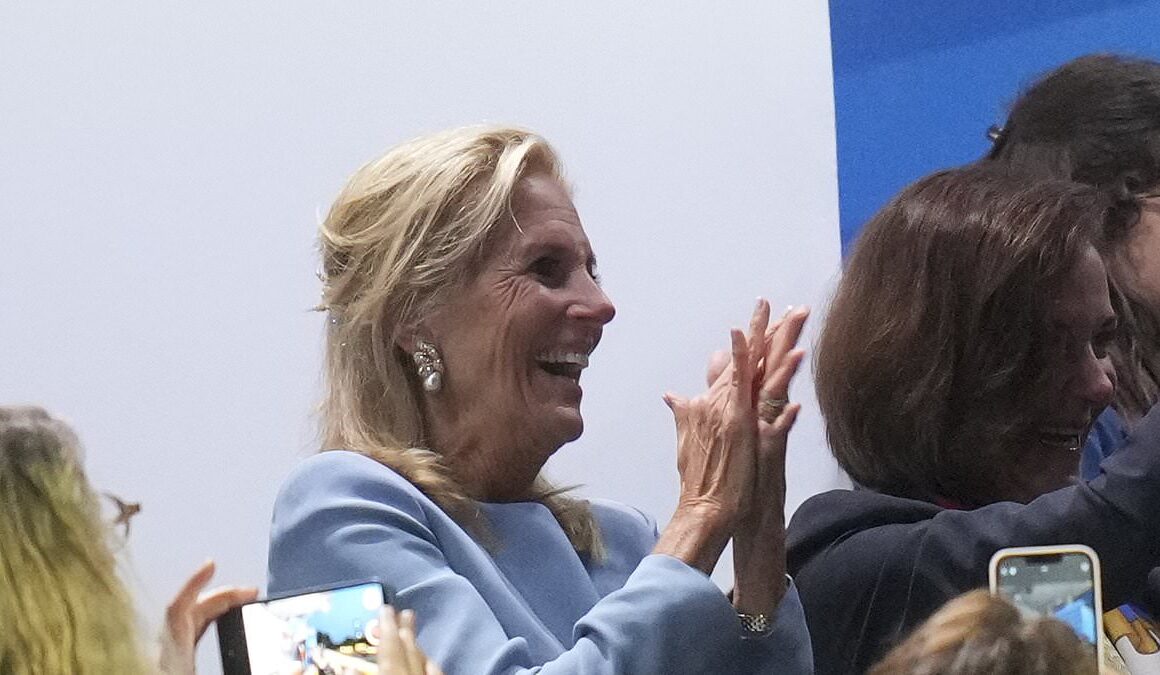 Jill Biden braves the rain and gets a hug from Emanuel Macron at the 2024 Olympics opening ceremony in Paris