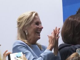 Jill Biden braves the rain and gets a hug from Emanuel Macron at the 2024 Olympics opening ceremony in Paris