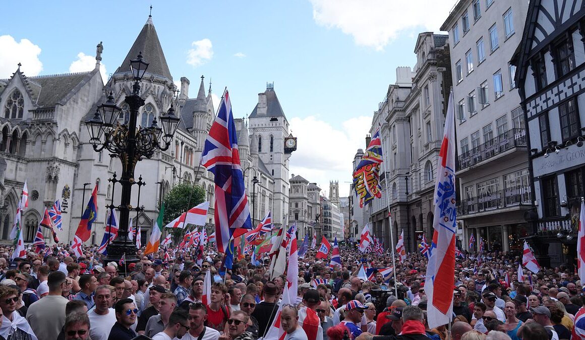 Thousands fill central London for Tommy Robinson rally amid chants of ‘We want our country back’ as Met police flood streets with 1,000 officers to keep the peace as capital with anti-racism counter-protest and Trans Pride event also due