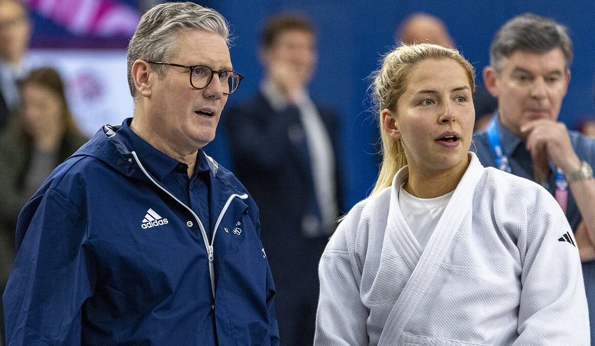 Keir Starmer wears his own Team GB Adidas jacket to meet British athletes at the Olympics (and it came in handy for the opening ceremony soaking!)