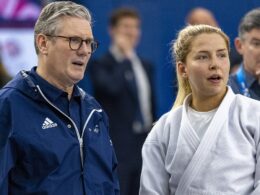 Keir Starmer wears his own Team GB Adidas jacket to meet British athletes at the Olympics (and it came in handy for the opening ceremony soaking!)