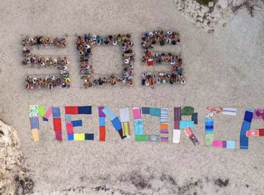 Hundreds of anti-tourism protesters form ‘SOS Menorca’ sign on idyllic beach ‘overrun’ by holidaymakers – after 20,000 took to the streets in Majorca