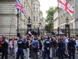 Flag-waving Tommy Robinson protesters chant ‘release Tommy now’ outside Downing Street after ‘arrest under anti-terror laws’