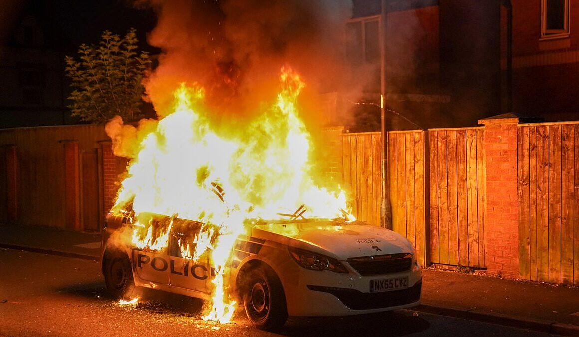 Second night of violence erupts in tinderbox Britain: Over 100 thugs are arrested, police cars are torched and more officers are injured in riots as anger continues to grow following Southport stabbings