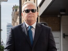 Body language expert claims that ‘confident’ Huw Edwards kept his inner emotions bottled up and showed ‘bravado’ as he walked into courtroom to admit making indecent images of children