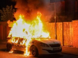 Boy, 11, is arrested on suspicion of arson after police car was set alight during protests in Hartlepool