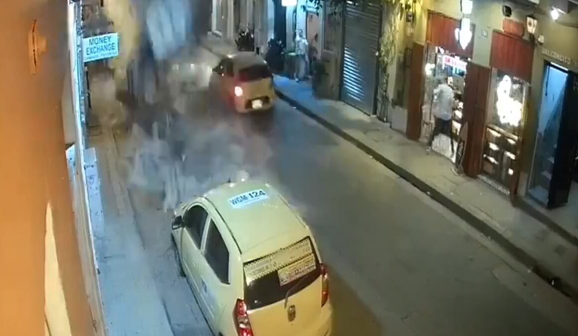 Frightening moment taxi is nearly crushed after balcony collapse in Colombia