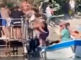 Shocking moment fists fly as brawl breaks out on a jetty with one man pushed off into a boat in row over who gets to take the next ferry home from idyllic Italian beach