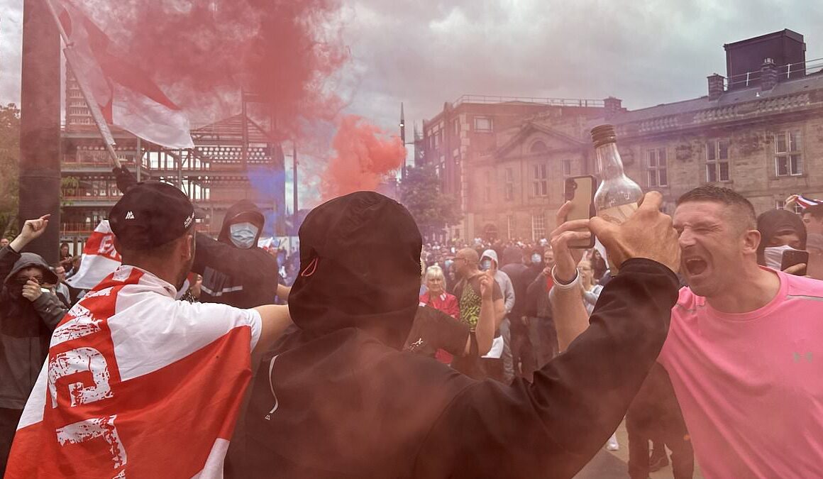 Britain braces for more riot mayhem: Masked protesters draped in England flags set off flares and attack cop cars in Sunderland, as police on horseback defend mosque from a large mob – amid fears of fresh far-right violence