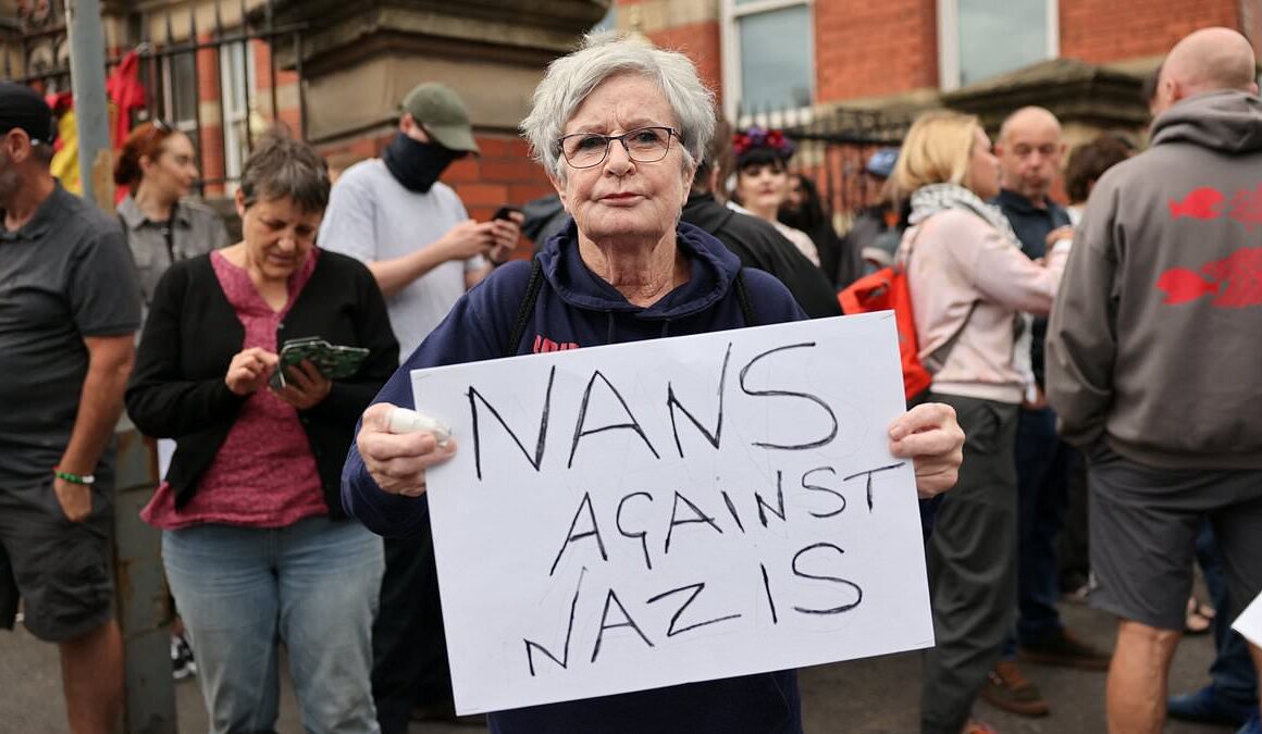 Nans against Nazis: Defiant Scouse pensioner, 71, takes to the frontline in Liverpool to protect mosque from ‘far-right protesters’ amid another night of rioting in Britain