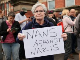 Nans against Nazis: Defiant Scouse pensioner, 71, takes to the frontline in Liverpool to protect mosque from ‘far-right protesters’ amid another night of rioting in Britain