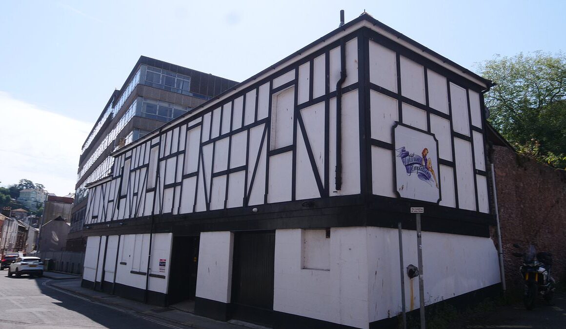 EXCLUSIVEAngry locals in Devon seaside town want mock Tudor building with no windows closed down because of its VERY dirty secret – but owner says ‘we’re a family business’