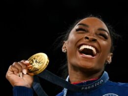 Beaming Biles bags Olympic gymnastics triple, as women’s 100m final looms