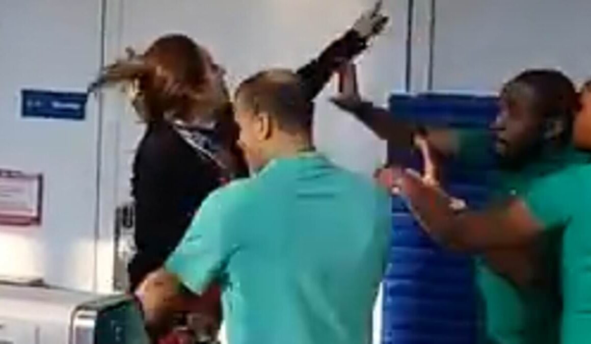 Moment raging woman hurls computer at Frontier Airlines staff ‘after missing flight from Chicago O’Hare Airport’