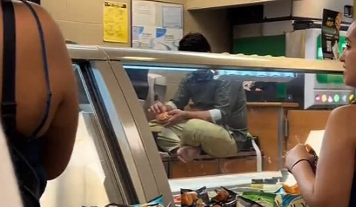 Stomach-churning moment Chicago Subway worker sits on food prep counter with his filthy BARE FEET and makes himself a sandwich