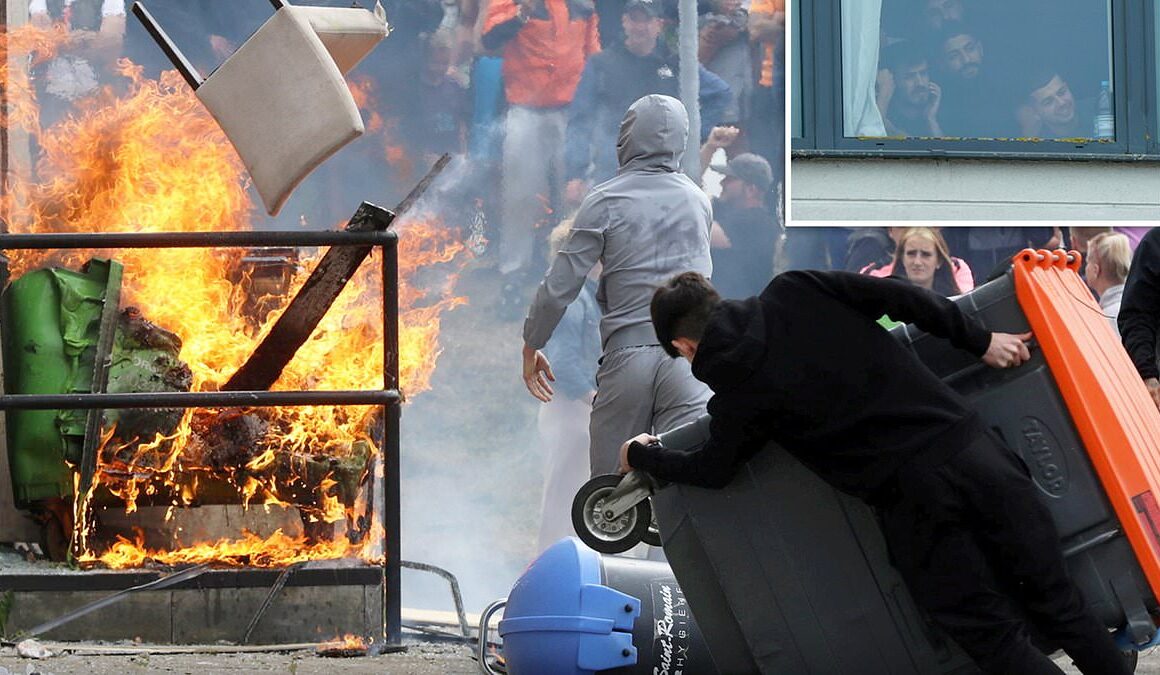 BREAKING NEWSBalaclava-clad baying mob storm migrant hotel, hurl chairs at riot police and set fire to furniture while terrified asylum seekers watch on from rooms in latest violent riots