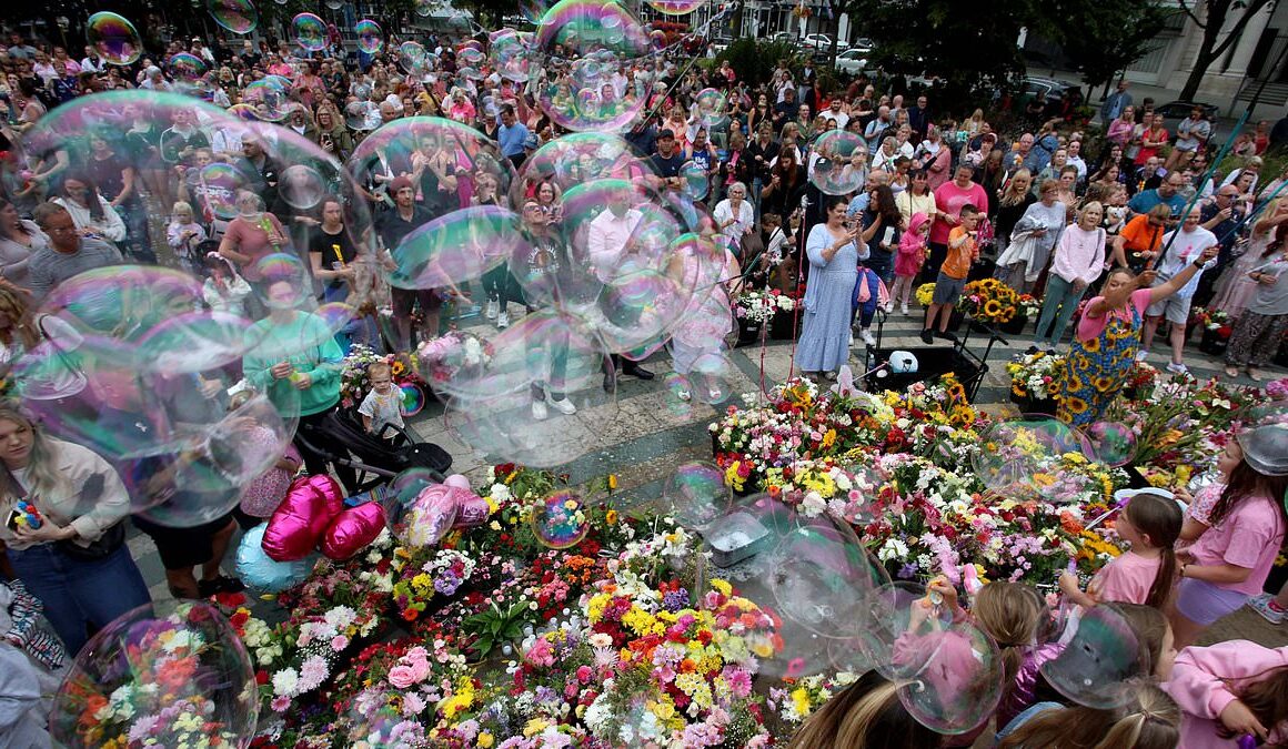 A town in mourning: Whilst far-right riots wreak havoc across England grieving Southport families lay flowers and blow bubbles a week after heartbreaking attack that left three little girls dead