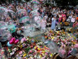 A town in mourning: Whilst far-right riots wreak havoc across England grieving Southport families lay flowers and blow bubbles a week after heartbreaking attack that left three little girls dead