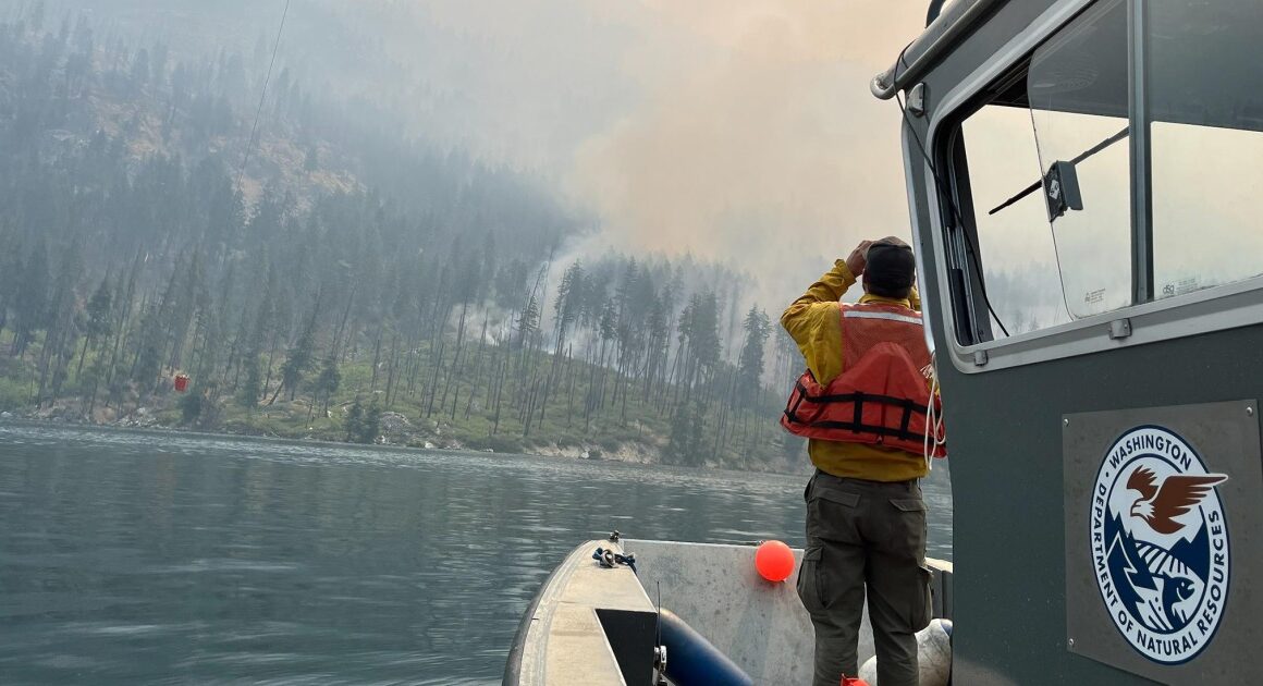 With a fire burning just miles away, residents of a Washington town dig in