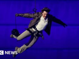 Tom Cruise abseils off stadium roof in daring Olympic finale