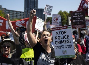 Some protesters tear down security fence as thousands march outside Democratic National Convention