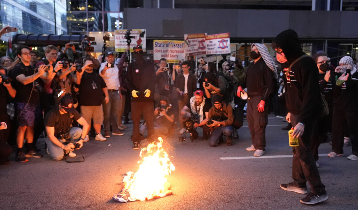 Man Tries to Rescue American Flag Burning Near DNC