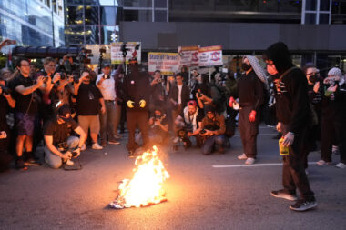 Man Tries to Rescue American Flag Burning Near DNC